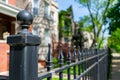 Black Metal Fence Post in front of a Row of Old Homes in Logan Square Chicago