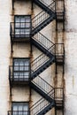 Black Metal Fire Escape Stairs Zig Zag and Connect Windows on the Way Down Royalty Free Stock Photo