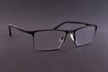 Black metal frame dioptric glasses on gray background Royalty Free Stock Photo