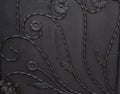 Black metal gate panel with flower design background texture Royalty Free Stock Photo