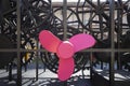 Black metal gear structure with a large pink propeller in the center Royalty Free Stock Photo