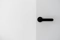 Black metal handle on white minimalist door Royalty Free Stock Photo