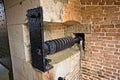 Black Metal lever that goes through an old brick fortress