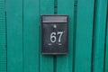 Black metal mailbox with number 67 Royalty Free Stock Photo