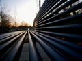 Black metal outdoor bench located on a sidewalk Royalty Free Stock Photo