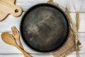 Black metal pan dish and tablecloth with wooden fork and spoon on table , a recipes food for healthy habits shot note background Royalty Free Stock Photo