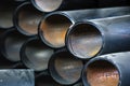 Black metal pipes and adapters of different diameters for gasification or water supply. Industrial background