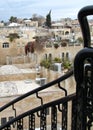 Black metal railing in front of Jerusalem Old City Jewish Quarter buildings and terraces