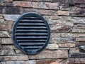 Black metal round shaped ventilation on the concrete brick wall Royalty Free Stock Photo