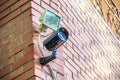 Black metal street security video camera on wall