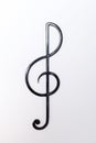 black metal treble clef on a light background. isolate Royalty Free Stock Photo