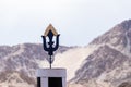 A black metal trident shot with defocused mountain in the background
