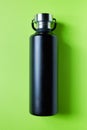 Black metal water bottle on green Royalty Free Stock Photo