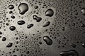 Black metal water drops on dark reflective surface Royalty Free Stock Photo
