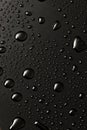 Black metal water drops on dark reflective surface Royalty Free Stock Photo