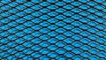 Black metallic mesh on blue cloth background Royalty Free Stock Photo