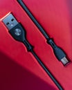 Black Micro-USB to USB cable connector on a red background Royalty Free Stock Photo