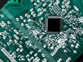 Microchip integrated on green motherboard computer science Royalty Free Stock Photo