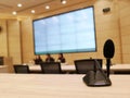 Black microphone in concert hall or conference meeting room or auditorium with defocused bokeh lights in background Royalty Free Stock Photo