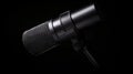 Black Microphone on Dark Background with Dramatic Lighting Effect Royalty Free Stock Photo