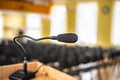 Black microphone in an empty conference hall, empty chair, ready for public speaking. Royalty Free Stock Photo