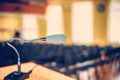 Black microphone in an empty conference hall, empty chair, ready for public speaking. Royalty Free Stock Photo