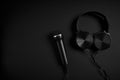 black microphone and headphones on a black background Royalty Free Stock Photo