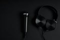 black microphone and headphones on a black background Royalty Free Stock Photo