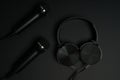 black microphone and headphones on a black background Royalty Free Stock Photo