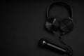 black microphone and headphones on a black background Royalty Free Stock Photo
