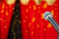 A black microphone on a stage. Royalty Free Stock Photo