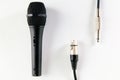 Black microphone with XLR and mono jack cable. Royalty Free Stock Photo