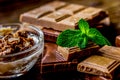 chocolate pieces with mint on wooden table background Royalty Free Stock Photo