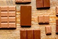 Black and milk chocolate pieces wooden table background top view Royalty Free Stock Photo