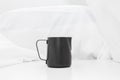 Black milk stainless pitcher object make coffee on white table and fabric background Royalty Free Stock Photo