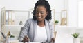 Black Millennial Businesswoman Taking Notes And Working On Laptop In Office