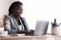 Black Millennial Businesswoman Using Laptop In Modern Office