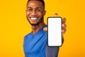 Black millennial gman showing white blank phone