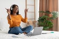 Black Woman Listening Music Using Laptop And Headphones In Bedroom Royalty Free Stock Photo