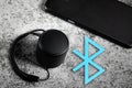 Black mini Bluetooth speaker and smartphone conected with Bluetooth