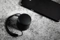 Black mini Bluetooth speaker and smartphone conected