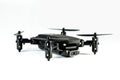 Black mini drone on a white background closeup. Spy technology