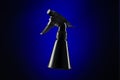 Black mini spray bottle over blue background Royalty Free Stock Photo