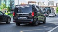 Black minivan Mercedes Vito is moving on the highway in the city Royalty Free Stock Photo