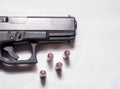 A black 9mm pistol with four hollow point bullets in front of it Royalty Free Stock Photo