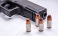 A black 9mm pistol with four hollow point bullets in front of it Royalty Free Stock Photo