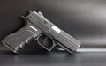 Black 9 mm pistol on a gray background