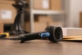 Black modern barcode scanner on wooden table in office, closeup. Online store Royalty Free Stock Photo