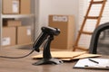 Black modern barcode scanner on wooden table in office. Online store Royalty Free Stock Photo