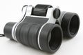 Black modern binoculars, laying flat